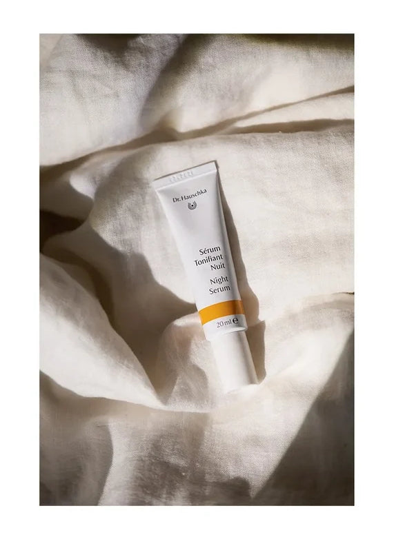 Dr Hauschka Night Serum styled on bed sheets