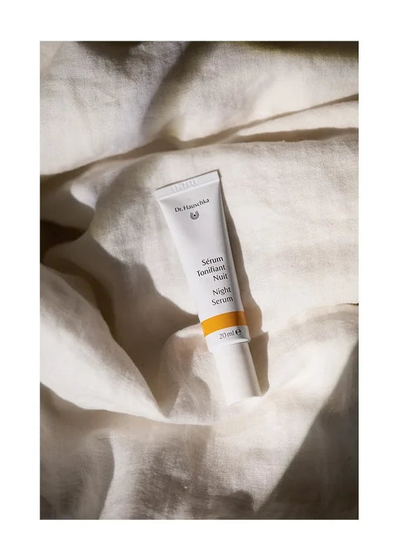 Dr Hauschka Night Serum styled on bed sheets