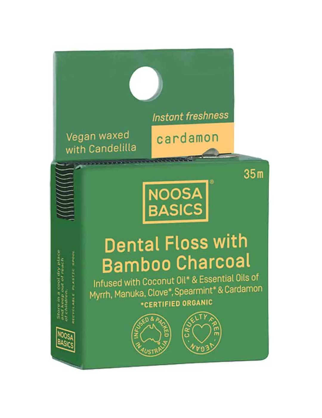 Green package of Noosa Basics dental floss with bamboo charcoal and cardamon on a white background