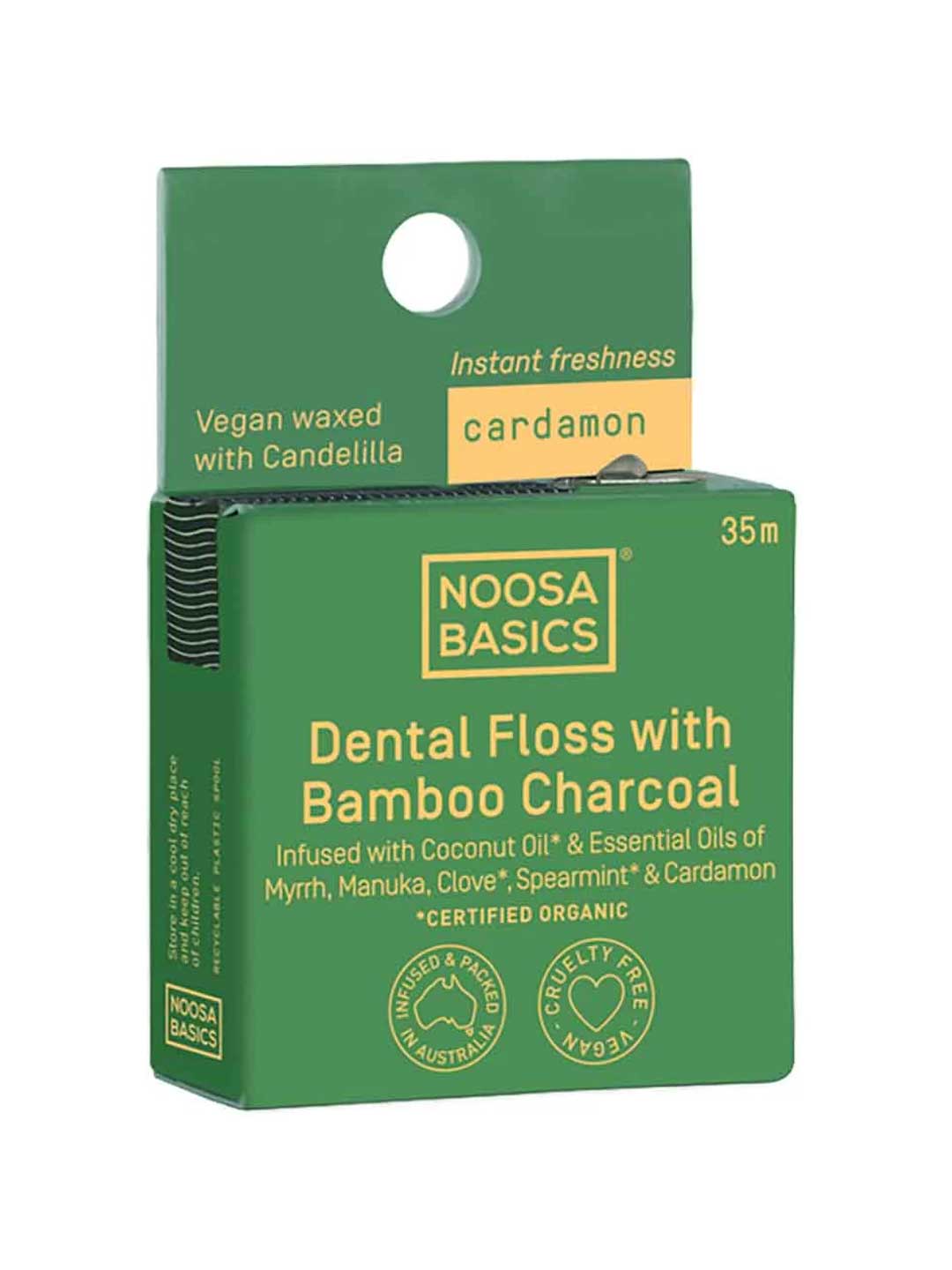 Green package of Noosa Basics dental floss with bamboo charcoal and cardamon on a white background