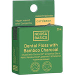 Green package of Noosa Basics dental floss with bamboo charcoal and cardamon on a white background