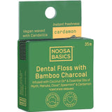 Green package of Noosa Basics dental floss with bamboo charcoal and cardamon on a white background