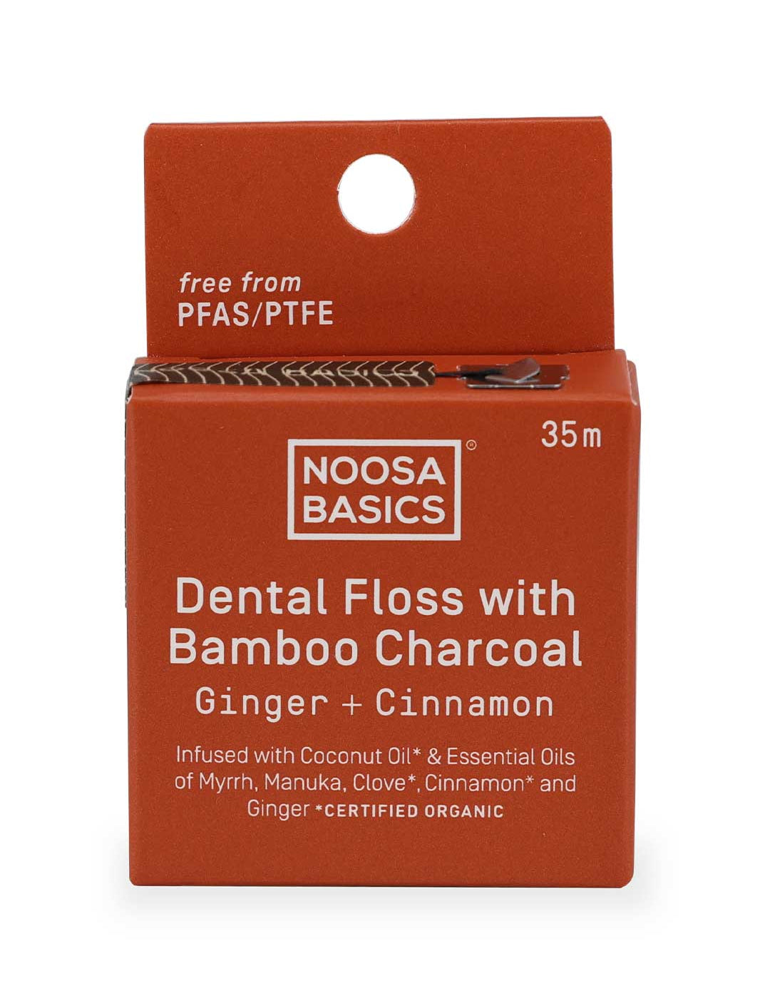 Noosa Basics dental floss packaging with bamboo charcoal and ginger cinnamon flavor on a white background