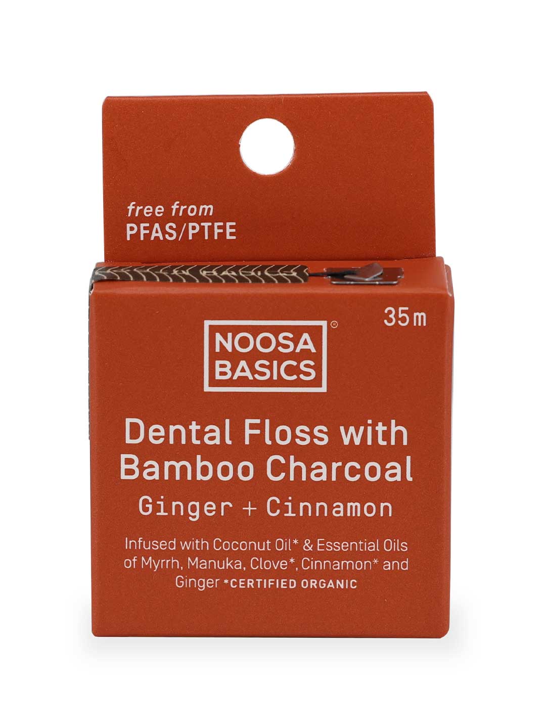 Noosa Basics dental floss packaging with bamboo charcoal and ginger cinnamon flavor on a white background