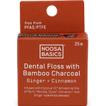 Noosa Basics dental floss packaging with bamboo charcoal and ginger cinnamon flavor on a white background