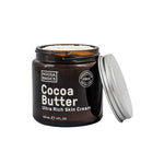 A jar of Noosa Basics Ultra Rich Skin Cream - Cocoa Butter 120ml with the lid off shows the rich cream inside; the dark brown jar with white text offers deep hydration in a 120 ml (4 fl oz) size.