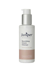 A white pump bottle labeled Juniper Nourishing Cream Cleanser 125ml, featuring a pale pink accent at the label’s base, stands out against a plain white background, emphasizing this hydrating cleanser for normal to dry skin.