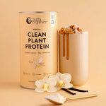 A canister of Nutra Naturals Clean Plant Protein Creamy Vanilla 500g stands beside a creamy vegan shake topped with granola. Vanilla pods, orchid flowers, and a scoop of plant protein powder are arranged in the foreground.
