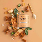 A container of Nutra Naturals Collagen Beauty Caramel 225g sits on a peach background, surrounded by orange roses, greenery, and caramel pieces. A gold spoon with white powder hints at enhanced skin hydration.