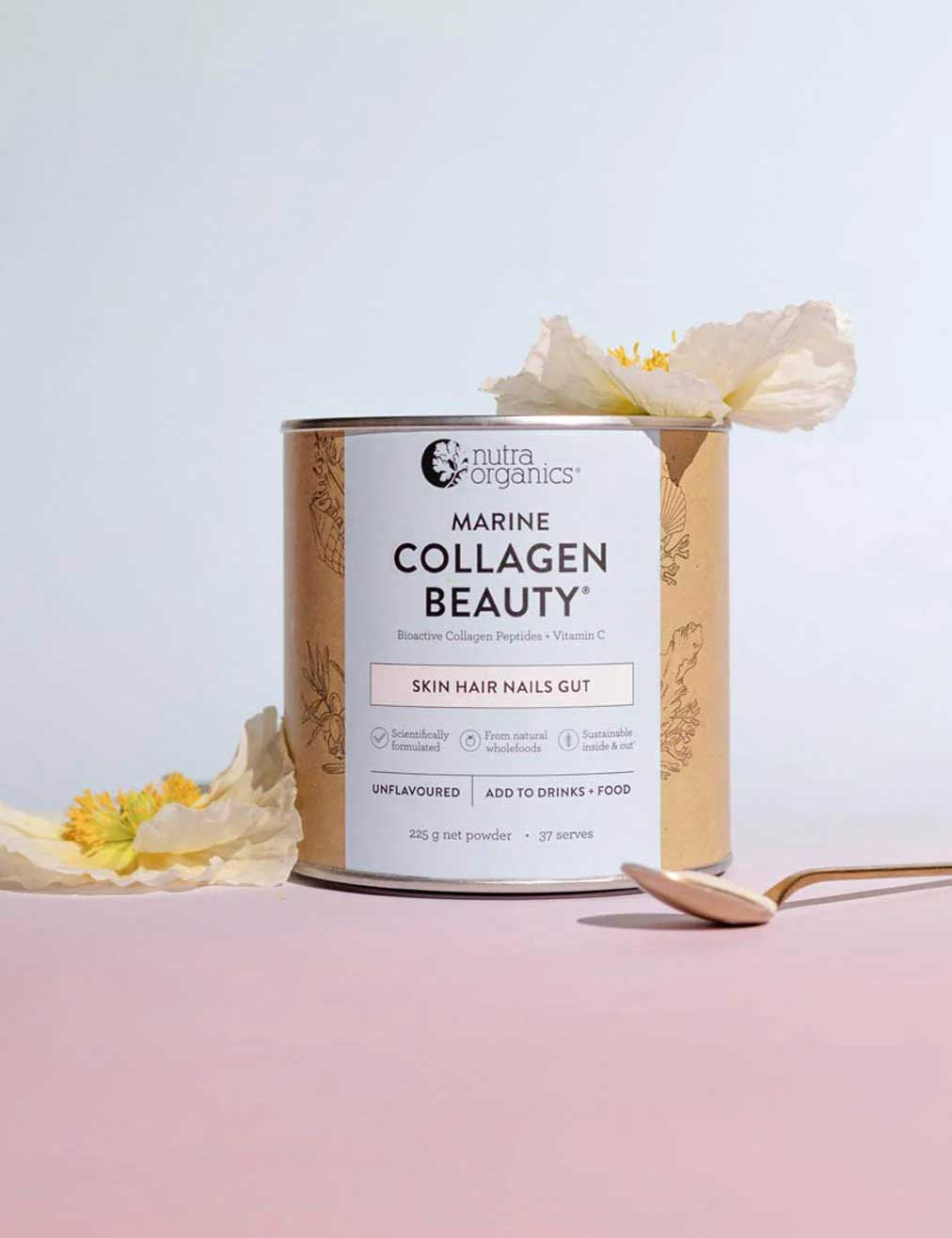 A canister of Nutra Naturals Marine Collagen Beauty Unflavoured 225g sits on a pink surface with a gold spoon and yellow-white flowers. This powder supports skin hydration and promotes healthy hair, nails, and gut.