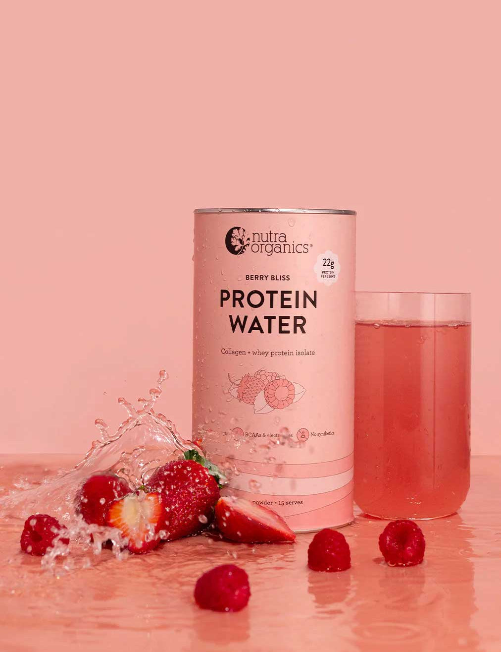 A canister of Nutra Naturals Protein Water Berry Bliss 450g stands beside a glass of the pink drink, surrounded by strawberries, raspberries, and water, all set against a pink background.