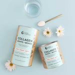 Two containers of Nutra Naturals Collagen Joints + Bones, a glass of water, a gold spoon with collagen powder, and three white daisies are arranged on a light blue background.