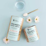 Two containers of Nutra Naturals Collagen Joints + Bones, a glass of water, a gold spoon with collagen powder, and three white daisies are arranged on a light blue background.