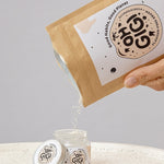 Oh Gigi Flavour-Free Hydroxyapatite Tooth Powder refill being poured into its glass jar