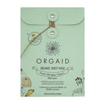 A mint green envelope-style package labeled Orgaid Organic Sheet Mask Firming, Anti-Aging + Vitamin C 4pck with floral illustrations. Includes four organic sheet masks that help firm, fight aging, and deliver vitamin C benefits.