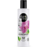 A white 280ml bottle of Organic Shop Orchid & Mint Luminous Glow Conditioner for normal hair, featuring orchid flowers, mint leaves, certification logos, and promoting a sulphate-free natural formula.