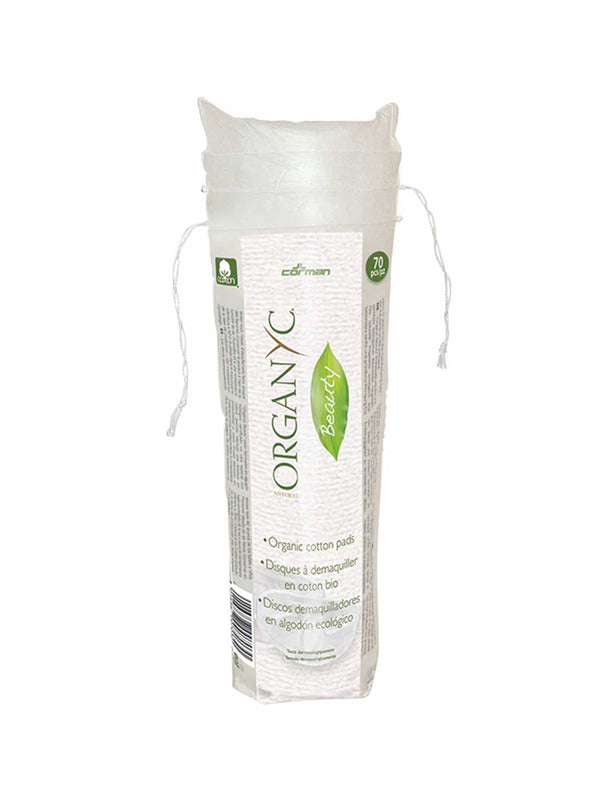 Tall transparent drawstring pack of stacked white Organyc cotton pads, wrapped with a white label featuring green lettering and a leaf-shaped emblem.
