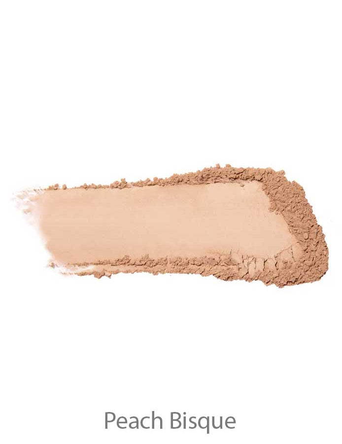 A swatch of 100% Pure Rice Powder Foundation 9g in Peach Bisque, a light peach-beige shade, features a smooth center with loose powder around the edges.
