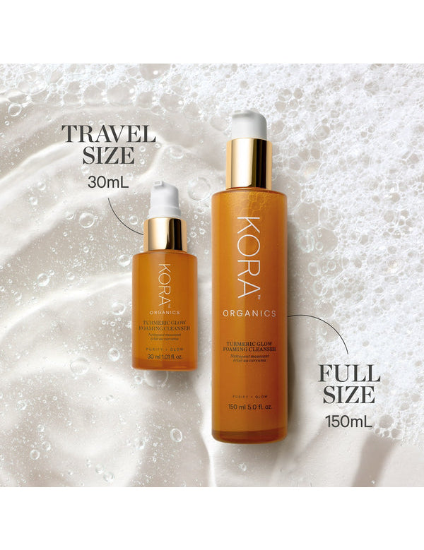 KORA Organics Turmeric Glow Foaming Cleanser travel size 30ml beside the full size