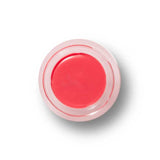 A small, round container of 100% Pure Lip & Cheek Tint in Pink Grapefruit, viewed from above, with a clear lid and smooth bright pink balm—a multipurpose tint for lips and cheeks.