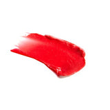 A swipe of 100% Pure Lip & Cheek Tint - Pink Grapefruit stands out in vibrant pink on a white background.