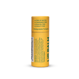 Back of a capped yellow Noosa Basics Paw Paw Lip Balm paper tube, showing green ingredient text, product information and a barcode.
