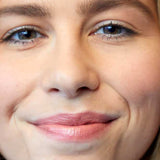 A close-up of a smiling woman’s face shows natural makeup with nourishing Luk Beautifood Lip Nourish Lipsticks 3g in a peach-toned shade. “Peach Melon” appears at the bottom of the image.