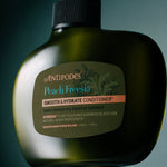 Antipodes Peach Freesia Smooth and Hydrate Conditioner bottle with product pour