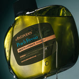 Antipodes Peach Freesia Smooth and Hydrate Shampoo bottle with product pour