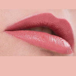 Close-up of lips wearing Benecos Natural Lipsticks 4.5g in a glossy pink shade, hydrating and enhancing your pout. The upper lip gently overlaps the lower, set against a matching pink background for a natural effect.