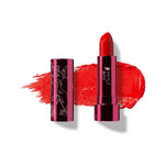 Hibiscus lipstick in vivid orange red, standing in a reflective pink tube beside its botanical patterned cap, with a matching bright red smear behind.