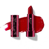 A tube of 100% Pure Pomegranate Oil Moisturising Lipstick 4.5g is shown in a floral-patterned metallic case, with a swatch of bright blood-red shade behind it. The shade is labeled Poppy (a bright, blood red).