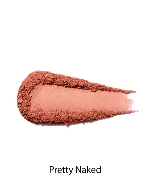 A swatch of matte, peachy-pink 100% Pure Rice Powder Pressed Blush 9g on a white background, labeled Pretty Naked below, highlights a natural flush with buildable coverage.