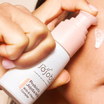 Applying The Jojoba Company Probiotic Jojoba Milk to the cheek