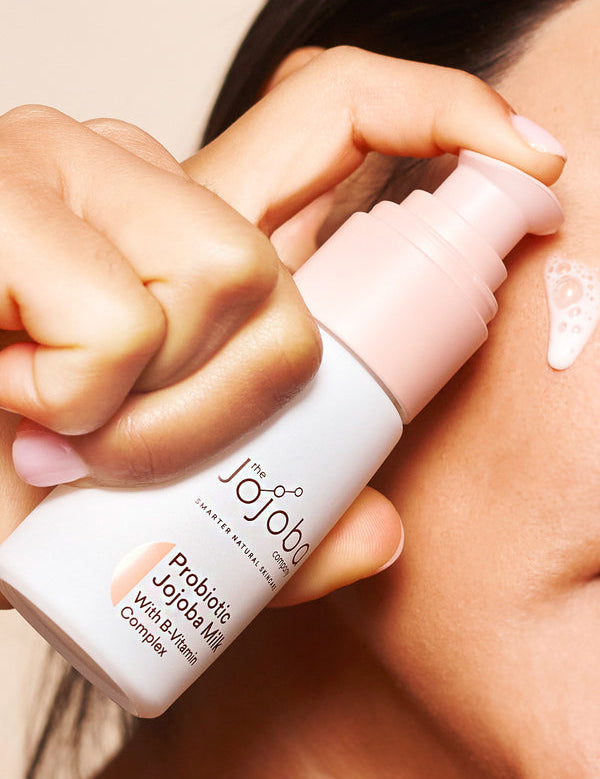 Applying The Jojoba Company Probiotic Jojoba Milk to the cheek