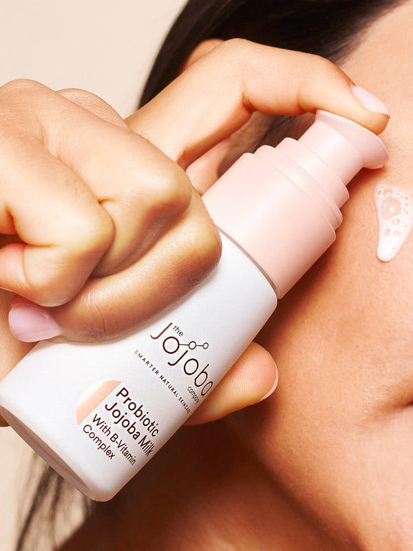 Applying The Jojoba Company Probiotic Jojoba Milk to the cheek