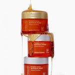 Honey drizzled over stacked jars of Andalou Brightening Pumpkin Honey Glycolic Mask