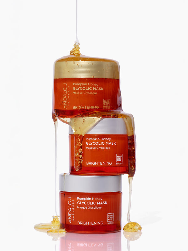 Honey drizzled over stacked jars of Andalou Brightening Pumpkin Honey Glycolic Mask