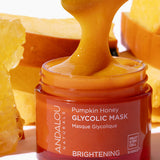 Andalou Brightening Pumpkin Honey Glycolic Mask open jar with spatula and natural ingredients