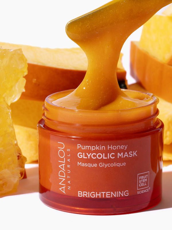 Andalou Brightening Pumpkin Honey Glycolic Mask open jar with spatula and natural ingredients