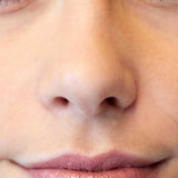 A close-up of a person’s lower face shows smooth skin and closed lips lightly glossed with Luk Beautifood Lip Nourish Lipsticks 3g, with the word "Pure" in the bottom left corner.