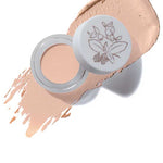 A 3g jar of 100% Pure Fruit Pigmented® Long Last Concealer with Super Fruits in Alpine Rose, featuring a white lid with floral art, shown next to a swatch of its light, rosy beige vegan formula.
