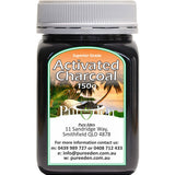 Squat black Pure Eden Activated Charcoal jar with a ribbed white screw lid and a green-bordered label showing palm trees beneath large white lettering.