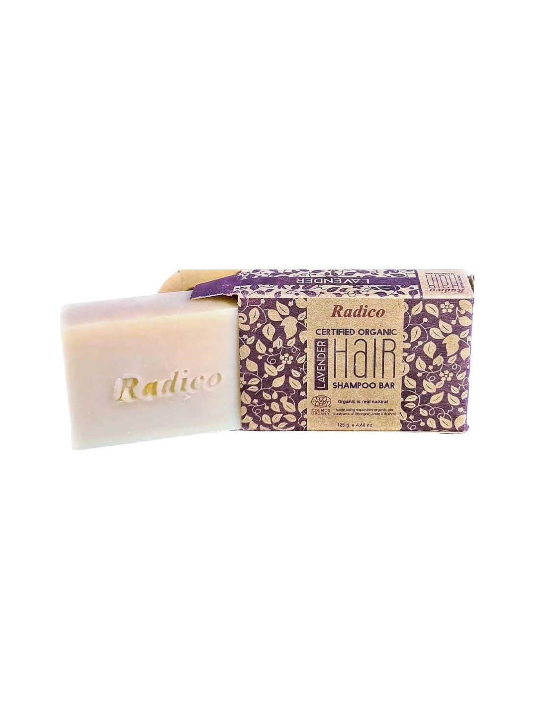 Cream rectangular Radico Lavender shampoo bar embossed with the Radico name, partly slid out of an open brown carton patterned with purple and cream leafy vines.