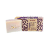 Cream rectangular Radico Lavender shampoo bar embossed with the Radico name, partly slid out of an open brown carton patterned with purple and cream leafy vines.