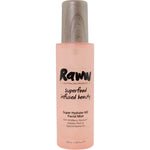 A pink bottle of Raww Hydrating Face Mist 100ml with a wooden-textured cap, featuring text about superfood-infused beauty and key ingredients for dewy skin.