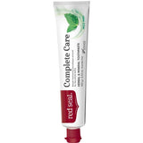 Slender white Red Seal Complete Care toothpaste tube standing on a small red cap, with large black lettering, a red logo panel and green mint leaves near the top.
