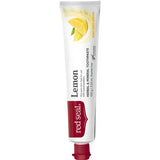 Slender white Red Seal Lemon toothpaste tube standing on a small red cap, with a red logo panel, black lettering and a yellow lemon wedge near the top.