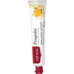 Slender white Red Seal Propolis toothpaste tube standing on a small red cap, with a red logo panel, black lettering and a golden honeycomb illustration near the top.