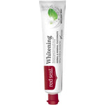 Slender white Red Seal Whitening toothpaste tube standing on a small red cap, with a red logo panel, black lettering and pale green mint leaves near the top.